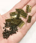 Bronze Miniature Door Hinges 12 Piece Set For 1 To 6 And 1 To 12 Scale Models Functional Open And Close Hardware With 48 Screws 18 By 15 Mm Perfect For Dollhouse Building And Craft Projects Morezmore M00598x6 in hand