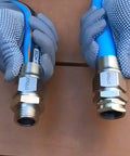 Gloved hands holding Heavy Duty 3/4 Inch Garden Hose Repair Kit with Stainless Steel Male and Female Ends, Lead Free Barb Water Hose Connectors.