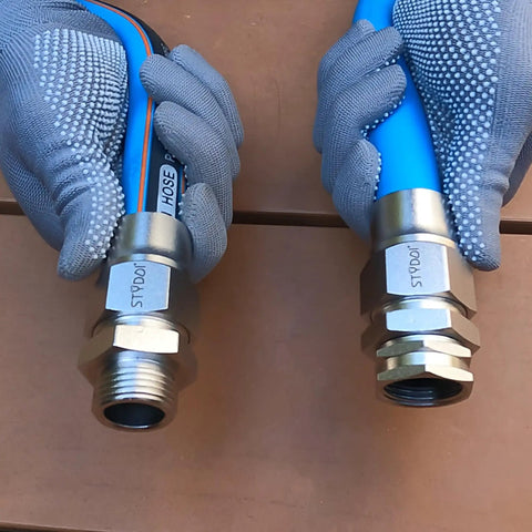 Gloved hands holding Heavy Duty 3/4 Inch Garden Hose Repair Kit with Stainless Steel Male and Female Ends, Lead Free Barb Water Hose Connectors.