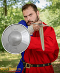 Man holding Old School Medieval Steel Buckler Shield Handcrafted With Wooden Grip, 16 Gauge, 30 Cm Round for LARP or Reenactment