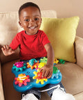 Child playing with Ocean Wonders Build And Spin Gears Toy Set, 17 Piece Preschool STEM Construction Kit For Toddlers And Kids 18 Months And Up