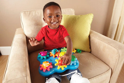 Child playing with Ocean Wonders Build And Spin Gears Toy Set, 17 Piece Preschool STEM Construction Kit For Toddlers And Kids 18 Months And Up