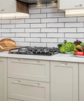 Modern kitchen with cabinets featuring 30 Pack Solid 3 Inch Square Foot Arch Cabinet Pulls In Brushed Nickel Finish, vegetables on countertop.