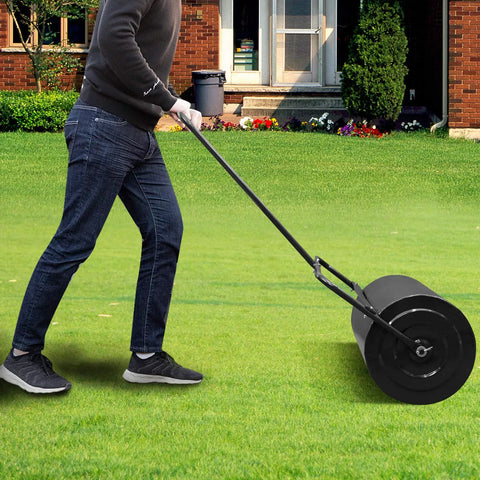 Person pushing Water Filled Lawn Roller For Garden And Lawn 16 Gallon Capacity 20 Inch Steel Drum Push Or Tow Behind Design