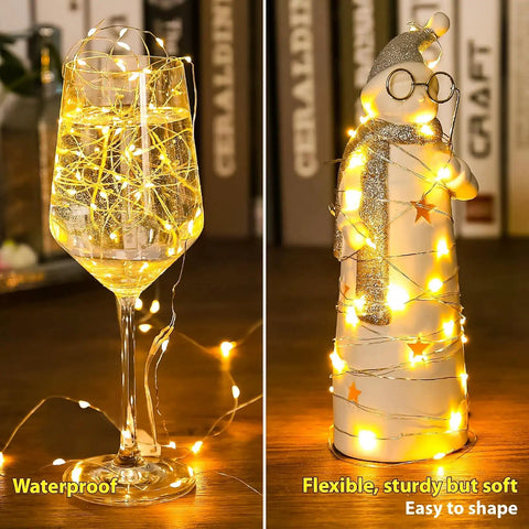 Six Pack Battery Operated Fairy Lights With 7 Foot Copper Wire And 20 LEDs Per String Warm White Firefly String Lights illuminating wine glass and snowman figurine indoors.