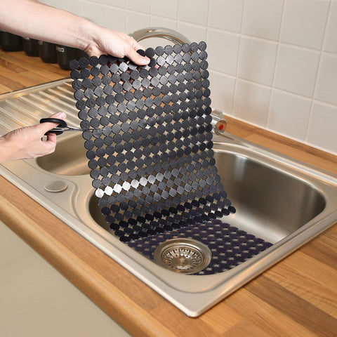 Person adjusting 2 Pack Kitchen Sink Mat Set For Stainless Steel And Ceramic Sinks, Eco Friendly PVC Bottom Protector, Black 11.8x15.7 inches.