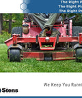Close-up of red ride-on lawn mower cutting grass in a garden, person driving with legs visible.