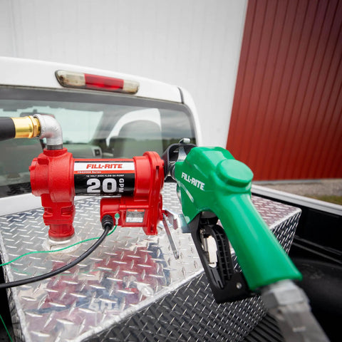 Heavy Duty 12V Fuel Transfer Pump With 20 GPM Flow Rate Cast Iron Construction Auto Shut Off Nozzle And Swivel Discharge Hose For Diesel Gasoline Kerosene And Biofuel Blends Built Like A Tank mounted on truck bed.