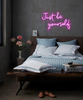 Pink USB Powered Neon Sign For Wall Decor LED Light Neon Art 'Just Be Yourself' above bed in cozy room
