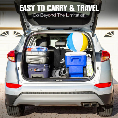 Car trunk loaded with luggage, cooler, and beach wagon with big sand wheels, ready for camping and outdoor adventures.