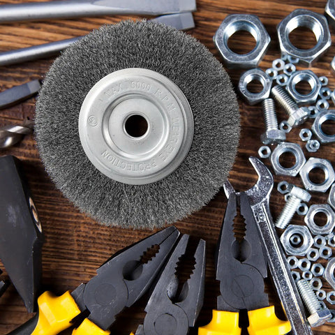 Six Pack Six Inch Carbon Steel Wire Wheel Brushes For Bench Grinders With Half To Five Eighth Arbor on a table with tools.