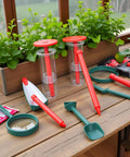 Six Pack Mini Seed Spreaders With Dibber Handheld Seed Planter Tools for precise garden planting on a wooden table.