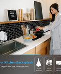 Woman installing 12 By 12 Inch Peel And Stick Backsplash Tiles For Kitchen And Bathroom In White Marble Pattern Easy Install No Mess Quick Peel And Stick For Kitchen Islands And Wall Backsplashes over a kitchen sink.