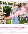 Woman in blue dress using Big Time Gender Reveal Sprayers 2 Pack Biodegradable Color Powder Blasters creating pink smoke.