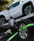 Man securing truck with Beefy Four Pack Car Tie Down Straps For Trailers With O Rings And Ratchets 2 Inch By 8 Foot Wheel Straps 10000 Lb Break Strength 3333 Lb Working Load Adjustable Lasso Style Haul Cars Trucks UTVs Green