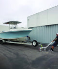 Heavy Duty Trailer Tug Man Moves Rv And Boat Trailers Up To 20K Lbs Capacity With 3500 Lb Tongue Weight Max. Boat on trailer being maneuvered.