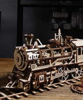 Wooden steam locomotive model kit made from unfinished basswood; natural wood finish with visible gears and wheels.