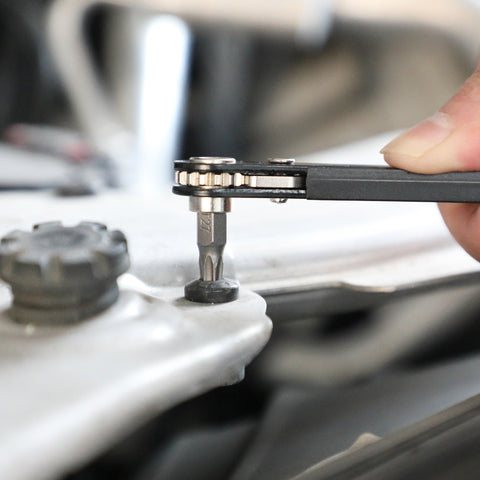 Using Tamper Proof Torx Bit Set With Mini Ratchet Wrench on auto part, showcasing precision fastening with a T27 bit.