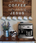 Kitchen setup with a clear coffee pod holder for K Cups and Vertuo capsules next to an espresso machine under a sign.