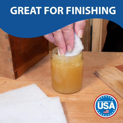Person using Top Notch 10 Pack Of 6 X 9 White Non Scratch Non Woven Buffing Pads For Wood Finishes and Wax Application.