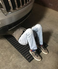 Person lying under a car on VersaMat Roll Up Workhorse High Density Foam Utility Mat Black For Garage And Home 1 Inch Thick Closed Cell Foam Heavy Duty Canvas Wrapped Portable 46 And Three Quarters By 25 Inch Roll Up Mat With Elastic Band