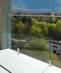 Glass balcony with Adjustable Glass Clamp Bracket For Stainless Steel Shelf Holder Railing, overlooking scenic valley.