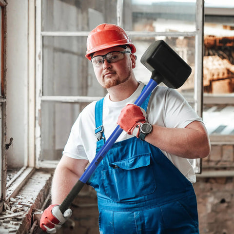 Worker holding 10 lb Rubber Mallet Dead Blow Hammer For Woodworking And Automotive Use, 35 Inch Handle, indoors