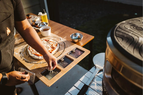 Large Bamboo Cutting Board With 3 Shatter Resistant Containers And Lids For Kitchen Prep on outdoor table with pizza topping