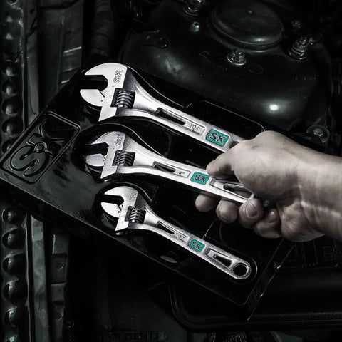 Hand holding Three Piece Adjustable Wrench Set 6 Inch 8 Inch 10 Inch Chrome Vanadium Steel SAE And Metric Scales on black tray