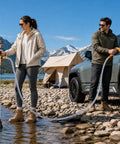 Heavy Duty Battery Powered Stick Water Pump With Three Speed Adjustable Motor being used by a woman on a rocky shore.