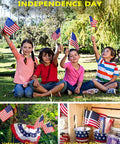 Children holding Pack Of 100 Small 4x6 Inch American Flags On 12 Inch Wood Sticks For Outdoor Use, celebrating Independence Day.