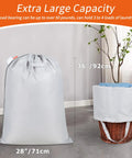 Extra Heavy Duty Laundry Bag With Handles 28 By 36 Inches Silver next to wicker basket, showing large capacity for 50 pounds