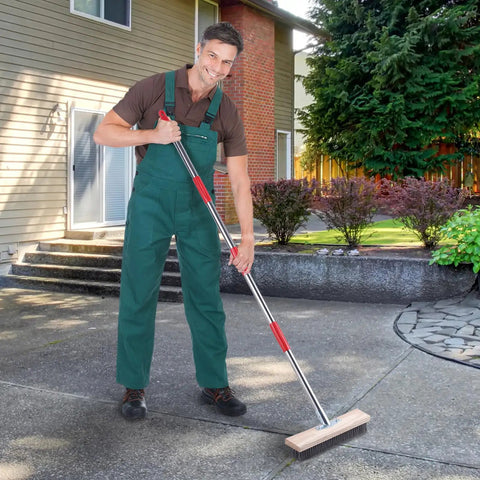 Man using a Heavy Duty Wire Scrub Brush With Telescopic Handle 57-Inch for Patio Deck Garage Driveway Concrete Outdoor Floors
