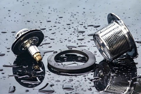 Heavy Duty Tub Drain Kit With Slick Push Pull Bathtub Strainer And Durable Zinc Alloy Body Plus Classic Chrome Finish components on wet surface.