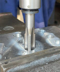 Pro Grade Right Hand Tap One And Five Sixteenths Inch 12 Threads Per Inch UN Machine Tap in use on metal surface