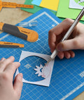 41-Piece Hobby Knife Set For Modeling And Crafting - Precision Exacto Style knife cutting paper on blue mat