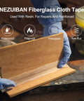 Workhorse Fiberglass Cloth Tape 2 Inch Wide By 50 Yards, 6 Oz, applied to wooden surface for repairs in workshop setting.