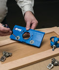 Person using Drawer Slide Jig And Concealed Hinge Jig Kit For Cabinets And Desks on a wooden cabinet door