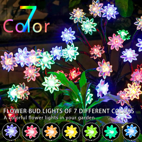 Colorful flower-shaped LED lights in seven different colors illuminating a garden at night.