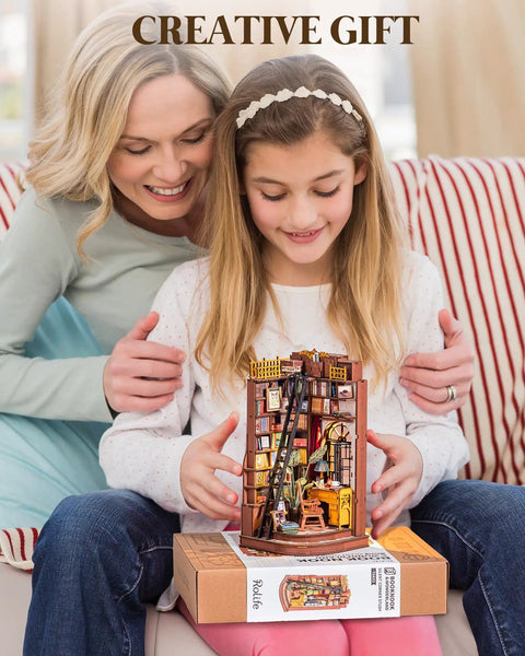 Child holding Dark Academia Book Nook Kit With LED Light 3 Hour Easy Build 3D Wooden Puzzle For Adults Beginner Friendly DIY Miniature