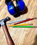 Jumbo Round Pencil 24 Pack Red With Medium Lead, USA Made Cedar Wood for carpenters alongside hammer and ear protection on a table