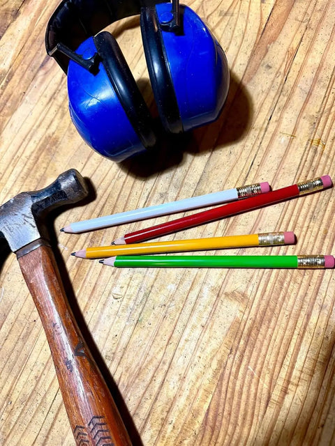 Jumbo Round Pencil 24 Pack Red With Medium Lead, USA Made Cedar Wood for carpenters alongside hammer and ear protection on a table