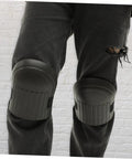 Built Tough Four Pack Black Heavy Duty Knee Pad Inserts For Work Pants Anti Slip Grip on worn jeans, providing support for work activities.