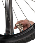 Triple Spoke Wrench For Bike Wheels, Heavy Duty Alloy Tool For Quick Wheel Truing shown in use on a bike wheel