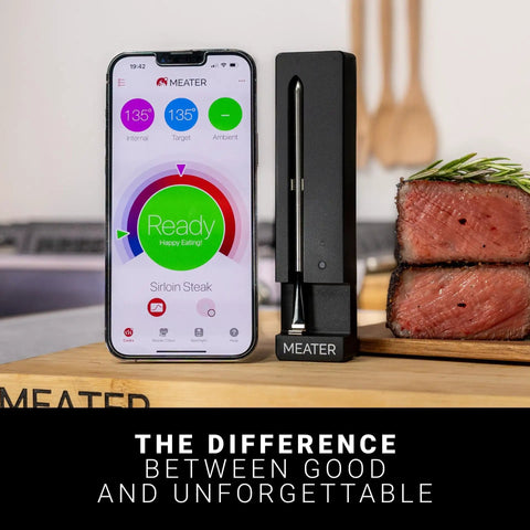 100 Percent Wireless Smart Meat Thermometer With Dual Temp Sensors next to smartphone app and cooked steak on board