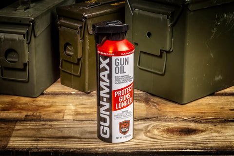 12 Ounce All In One Gun Oil And Cleaner Heavy Duty Lubricant And Rust Protectant Bottle on wooden table with ammo boxes