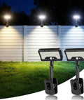 Heavy Duty Solar Motion Lights Clip On For Fence Deck And Gutter 92 Led Security Spotlight brightening a fence at night.