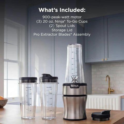 Heavy Duty Personal Blender Featuring 900W Push To Blend Motor And Pro Extractor Blades Crushing Ice For Nutrient Dense Smoothies Including Three Grab And Go 20 Oz Serveware Cups In Classic Silver on kitchen countertop.