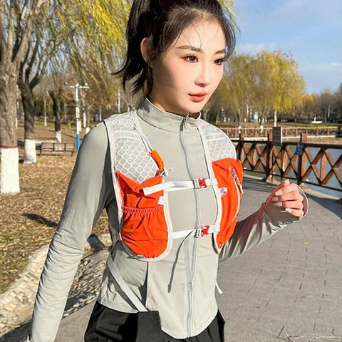 Runner wearing Lightweight Running Hydration Pack with Built In Water Reservoir, Snug Fit Backpack for Runners, Orange