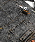 Close-up of black denim apron with deep pockets for tools, adjustable cross back straps, 100 percent cotton.